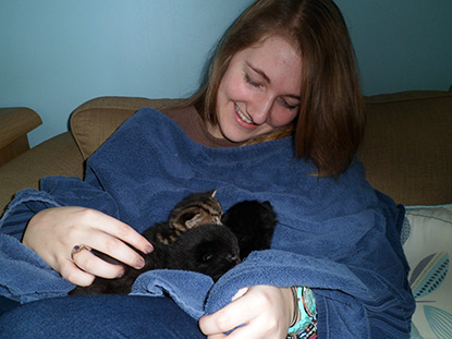 Charlotte cuddling kittens